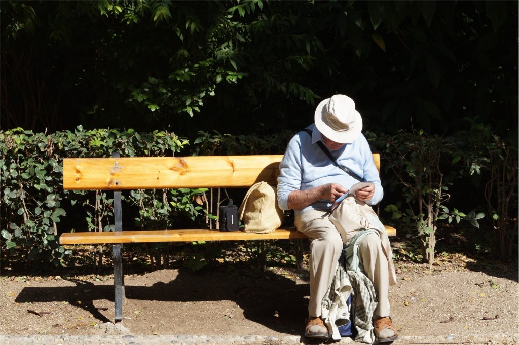 Older guy, sat on a bench