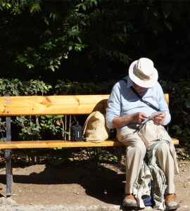 Older guy, sat on a bench